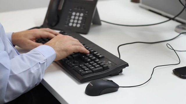 Professional man typing computer keyboard office work space