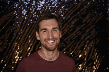 Portrait of a cute guy. A young man is smiling at the camera. Good mood and positive.