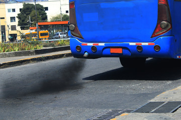 An auto bus polluting the environment with black smog coming from the exhaust pipe
