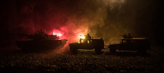 Military patrol car on sunset background. Army war concept. Silhouette of armored vehicle with...