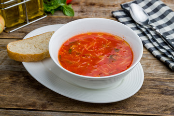 Soup of tomato on wooden table