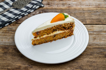 Carrot cake on plate on wooden table