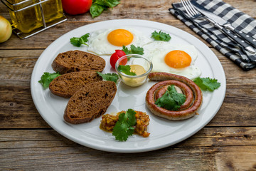 English Breakfast on a plate on wooden table