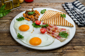 English Breakfast on a plate on wooden table
