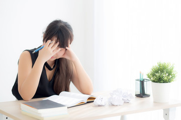 Beautiful asian woman tired and stressed with writing overworked at desk, girl with worried not idea with notebook and crumpled paper at office, freelance and business concept.