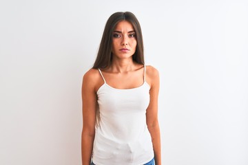 Young beautiful woman wearing casual t-shirt standing over isolated white background Relaxed with serious expression on face. Simple and natural looking at the camera.
