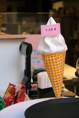 White ice cream cone with pink price ticket.