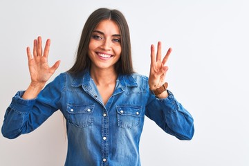 Young beautiful woman wearing casual denim shirt standing over isolated white background showing and pointing up with fingers number eight while smiling confident and happy.