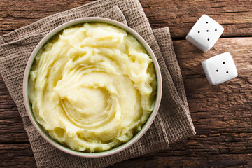 Fresh homemade creamy mashed potato in bowl, photographed overhead (Selective Focus, Focus on the...