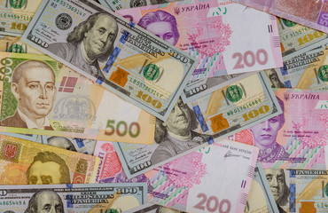 Colorful of different banknotes Ukrainian national currency bills and American dollars money and...
