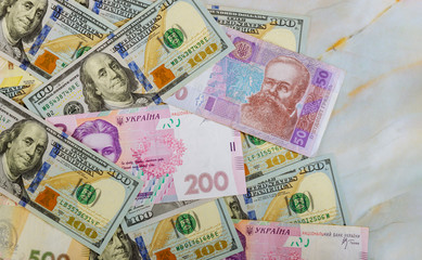 Cash money finance investment American dollars banknotes and Ukrainian Money.