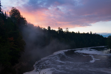 Sunrise over river with steam