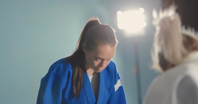 Greeting athletes before the fight. Girls tune into battle, serious look. Portrait view.