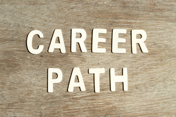 Alphabet letter in word career path on wood background