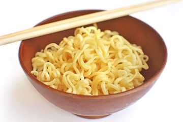 Instant noodles in wood bowl on white background