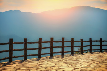 Looking over the mountains in front of the railing