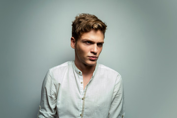 Obraz premium Serious teenager in white shirt, fashion studio shot 