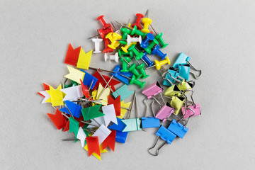 Set of different colorful plastic stationery buttons on grey background. Office stationery. Sharp...