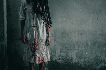 Girl zombie in the blood.The ghost of a woman stand with blood. horror of scary fear on hell is...
