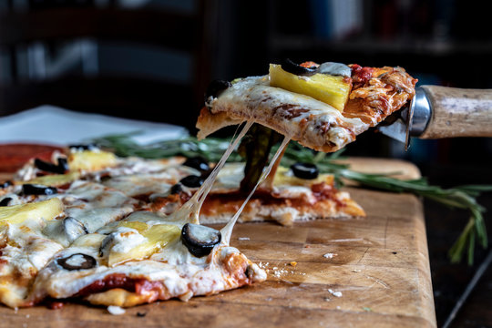 Pizza Slice Being Served With Stretchy Cheese