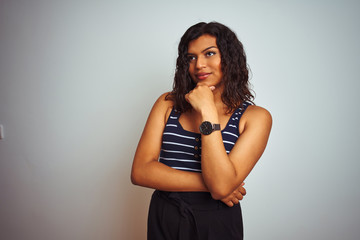 Transsexual transgender woman wearing striped t-shirt over isolated white background looking confident at the camera smiling with crossed arms and hand raised on chin. Thinking positive.