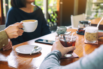 Closeup image of people enjoyed drinking coffee together in cafe