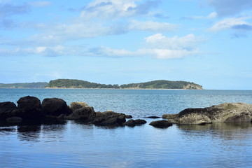 View of tiny Saddle Island from inside of Mahurangi Harbour near Auckland in New Zealand.