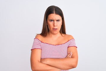 Obraz premium Portrait of beautiful young woman standing over isolated white background skeptic and nervous, disapproving expression on face with crossed arms. Negative person.