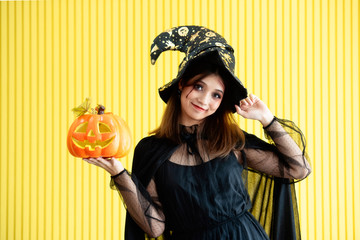 An Asian beautiful woman model dressed as a witch and a witch's hat costume smile and acting on...