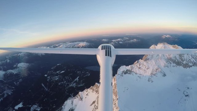 Sunset Flying with a glider through the austrian alps.