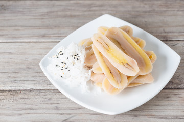 Boiled slice banana eat with coconut