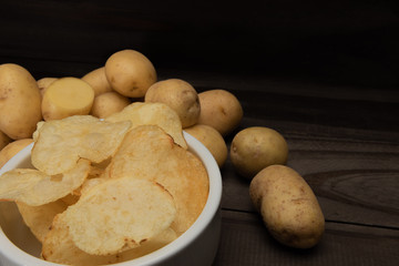  potatoes and french fries on wooden background