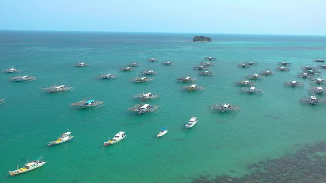 Aerial view of drone fliying over fishing boat at Tanjung Binga fishing Village in Belitung Island Indonesia. Fishing Boat on Clear water.