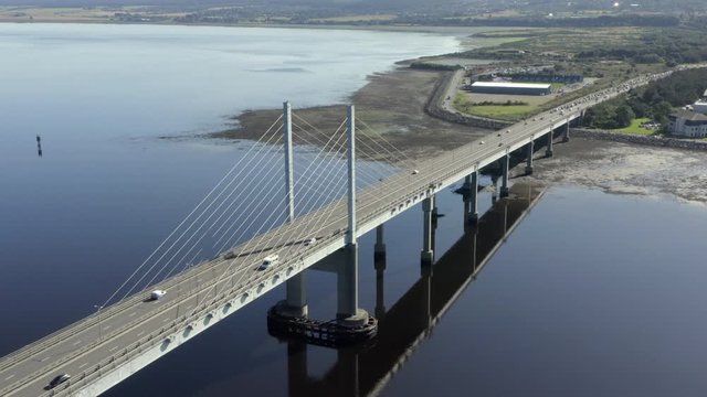 An aerial view of Kessock Bridge in Inverness on a sunny summer's morning. Rotating anti-clockwise around the western and southern side of the bridge.