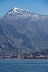 Fototapeta na wymiar View of a village and cliffs surrounding the Bay of Kotor in Montenegro