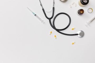 Creative flatlay of doctor medical equipment white table with stethoscope, medical documents, thermometer, syringe and pills, Health care concept, Top view with copy space, Isolated on white