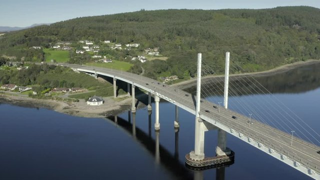 An aerial view of Kessock Bridge in Inverness on a sunny summer's morning. Flying towards the western and northern side of the bridge whilst zooming in.