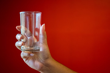 A glass of water with a red scene