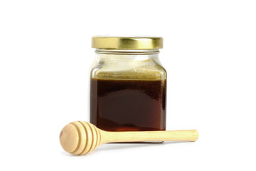 ็Honey dipper and Natural  honey in jar on white background.