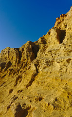 Yellow cliffs with blue sky in background