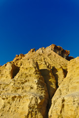 Fototapeta premium Yellow cliffs with blue sky in background