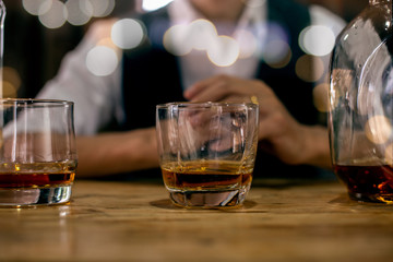 glass of whiskey and cigar on table