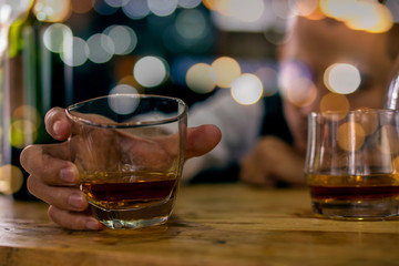 glass of beer on wooden table in a cafe