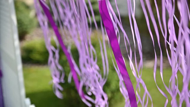 Wedding ceremony decoration on wind. Wind blows colorful ribbons in spring sunlight