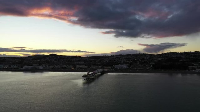 Paignton Pier slow pn sunset Devon UK. Aerial view using a drone.