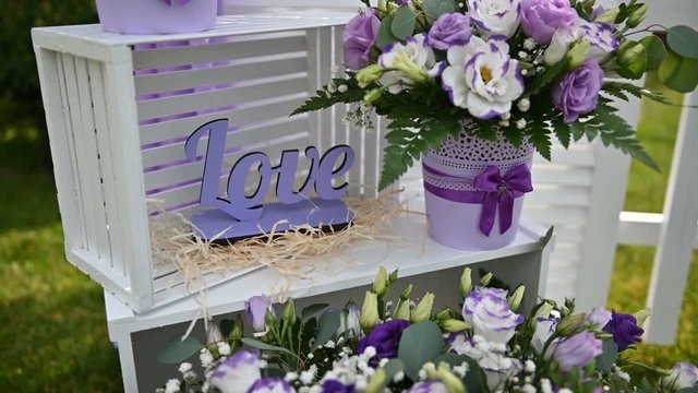 beautiful purple flowers near the arch for an outdoor ceremony