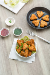 Heart shape cutlets with sauce and green chutney