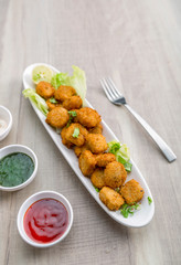 Button cutlets with sauce and green chutney