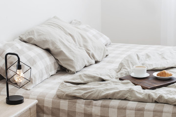 coffee on  tray on the bed in bedroom