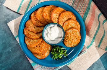 Homemade potato pancakes, latkes, draniki, hash browns or fritters served with sour cream and...
